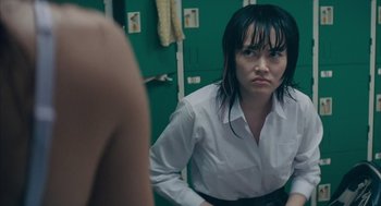 Movie still from “Babel” (2006), directed by Alejandro G. Iñárritu – A woman standing in front of a mirror in a room; Close Up shot, Over the shoulder angle