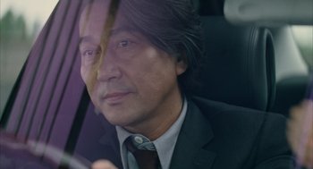 Movie still from “Babel” (2006), directed by Alejandro G. Iñárritu – A person wearing a suit and tie; Close Up shot, Low angle