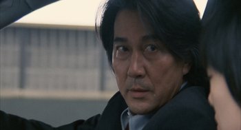 Movie still from “Babel” (2006), directed by Alejandro G. Iñárritu – A person wearing a jacket; Close Up shot, Low angle