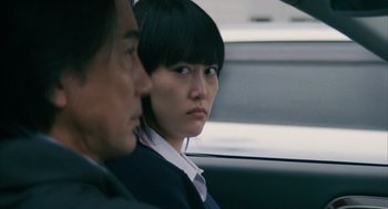 Movie still from “Babel” (2006), directed by Alejandro G. Iñárritu – A man and a woman sitting in the back seat of a car; Close Up shot, Over the shoulder angle