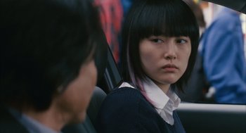 Movie still from “Babel” (2006), directed by Alejandro G. Iñárritu – A young woman sitting in a car looking into the mirror; Close Up shot, Over the shoulder angle
