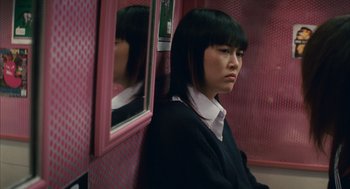 Movie still from “Babel” (2006), directed by Alejandro G. Iñárritu – A woman sitting in front of a mirror on a train; Close Up shot, Low angle