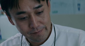 Movie still from “Babel” (2006), directed by Alejandro G. Iñárritu – A person wearing a white shirt; Extreme Close Up shot, Low angle