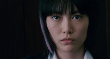 Movie still from “Babel” (2006), directed by Alejandro G. Iñárritu – A person with purple hair; Close Up shot, Low angle