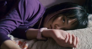 Movie still from “Babel” (2006), directed by Alejandro G. Iñárritu – A young woman laying on a bed with her arm resting on the pillow; Close Up shot, High angle