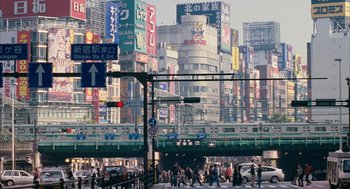 Movie still from “Babel” (2006), directed by Alejandro G. Iñárritu – A busy city street with lots of traffic and buildings; Extreme Wide shot, High angle