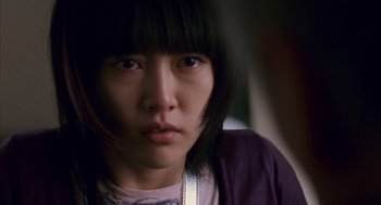 Movie still from “Babel” (2006), directed by Alejandro G. Iñárritu – A person wearing a purple shirt; Close Up shot, Over the shoulder angle