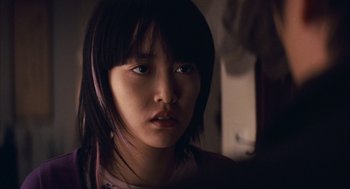 Movie still from “Babel” (2006), directed by Alejandro G. Iñárritu – A young asian woman with long black hair; Close Up shot, Over the shoulder angle