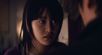 Movie still from “Babel” (2006), directed by Alejandro G. Iñárritu – A young woman with long black hair looking at the camera; Close Up shot, Over the shoulder angle