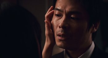 Movie still from “Babel” (2006), directed by Alejandro G. Iñárritu – A person holding his hand up to his ear; Extreme Close Up shot, Over the shoulder angle