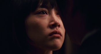 Movie still from “Babel” (2006), directed by Alejandro G. Iñárritu – A person looking to their left; Extreme Close Up shot, Over the shoulder angle