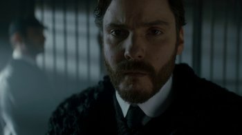 Movie still from “The Alienist” (2018), created by Cary Joji Fukunaga – A person wearing a suit and tie; Close Up shot, Low angle