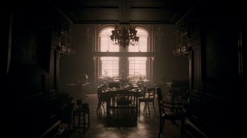 Movie still from “The Alienist” (2018), created by Cary Joji Fukunaga – A dining room with a table and chairs in the middle of the room; Extreme Wide shot, High angle