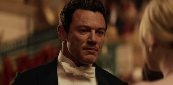 Movie still from “The Alienist” (2018), created by Cary Joji Fukunaga – A person wearing a tuxedo; Close Up shot, Over the shoulder angle