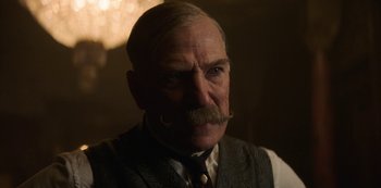 Movie still from “The Alienist” (2018), created by Cary Joji Fukunaga – An older man with a mustache and a mustache ring; Close Up shot, Low angle