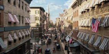 Movie still from “The Alienist” (2018), created by Cary Joji Fukunaga – An image of an old time city street scene; Extreme Wide shot, High angle