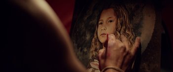 Movie still from “The Bad Batch” (2016), directed by Ana Lily Amirpour – A painting of a young girl being painted by an artist; Extreme Close Up shot, Low angle