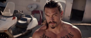 Movie still from “The Bad Batch” (2016), directed by Ana Lily Amirpour – A person with long hair; Close Up shot, Over the shoulder angle