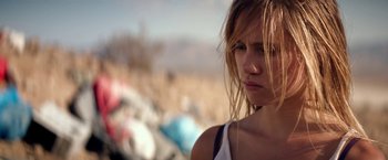 Movie still from “The Bad Batch” (2016), directed by Ana Lily Amirpour – A person wearing a tank top; Close Up shot, Low angle