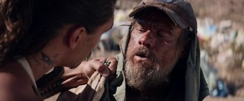 Movie still from “The Bad Batch” (2016), directed by Ana Lily Amirpour – A man with a beard and a hat is looking at another man's face; Close Up shot, Over the shoulder angle