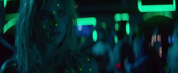 Movie still from “The Bad Batch” (2016), directed by Ana Lily Amirpour – A woman with blonde hair and green lights in the background; Close Up shot, Low angle