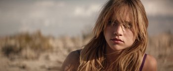 Movie still from “The Bad Batch” (2016), directed by Ana Lily Amirpour – A person with long brown hair; Close Up shot, Low angle