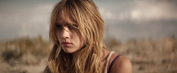 Movie still from “The Bad Batch” (2016), directed by Ana Lily Amirpour – A person with long blonde hair; Close Up shot, Low angle