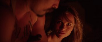 Movie still from “The Bad Batch” (2016), directed by Ana Lily Amirpour – A man and a woman looking into each other's eyes; Close Up shot, Over the shoulder angle