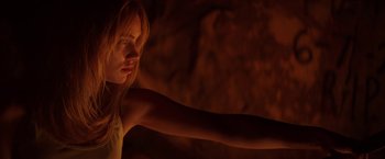 Movie still from “The Bad Batch” (2016), directed by Ana Lily Amirpour – A woman with her arm outstreched in the dark; Close Up shot, Low angle