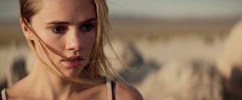 Movie still from “The Bad Batch” (2016), directed by Ana Lily Amirpour – A person with long hair; Close Up shot, Low angle