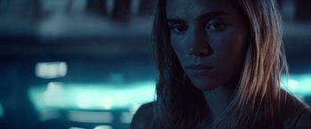 Movie still from “The Bad Batch” (2016), directed by Ana Lily Amirpour – A person with long brown hair; Close Up shot, Low angle