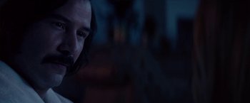 Movie still from “The Bad Batch” (2016), directed by Ana Lily Amirpour – A person with long dark hair; Close Up shot, Over the shoulder angle