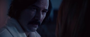 Movie still from “The Bad Batch” (2016), directed by Ana Lily Amirpour – A person with a mustache; Close Up shot, Over the shoulder angle