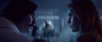 Movie still from “The Bad Batch” (2016), directed by Ana Lily Amirpour – Two people are facing each other in a room; Close Up shot, Over the shoulder angle