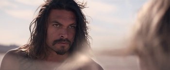 Movie still from “The Bad Batch” (2016), directed by Ana Lily Amirpour – A person with long black hair; Close Up shot, Low angle