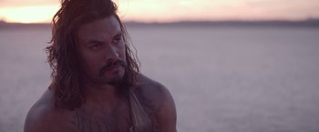 Movie still from “The Bad Batch” (2016), directed by Ana Lily Amirpour – A person with long hair; Close Up shot, Over the shoulder angle