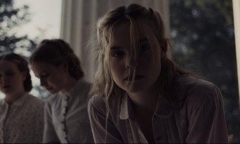 Movie still from “The Beguiled” (2017), directed by Sofia Coppola – A woman sitting next to another woman in front of a window; Close Up shot, Low angle