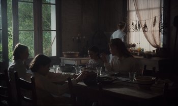 Movie still from “The Beguiled” (2017), directed by Sofia Coppola – A group of people sitting around a table; Wide shot, High angle