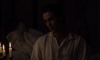 Movie still from “The Beguiled” (2017), directed by Sofia Coppola – A man in white shirt sitting in a dark room; Medium shot, Over the shoulder angle