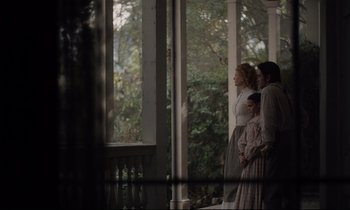 Movie still from “The Beguiled” (2017), directed by Sofia Coppola – A group of people standing next to a window; Wide shot, Over the shoulder angle