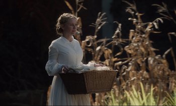Movie still from “The Beguiled” (2017), directed by Sofia Coppola – A woman in a white dress holding a basket; Medium shot, Over the shoulder angle