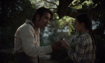 Movie still from “The Beguiled” (2017), directed by Sofia Coppola – A man and a woman holding a camera in a forest; Medium shot, Over the shoulder angle