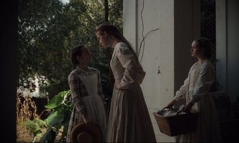 Movie still from “The Beguiled” (2017), directed by Sofia Coppola – Two women dressed in period clothing talking to each other; Medium shot, Low angle
