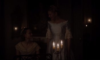 Movie still from “The Beguiled” (2017), directed by Sofia Coppola – Two women are standing next to lit candles in a room; Medium shot, Over the shoulder angle