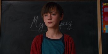 Movie still from “The Book of Henry” (2017), directed by Colin Trevorrow – A young boy standing in front of a blackboard; Close Up shot, Over the shoulder angle