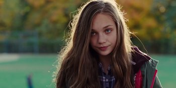 Movie still from “The Book of Henry” (2017), directed by Colin Trevorrow – A young girl with long brown hair wearing a plaid shirt; Close Up shot, High angle