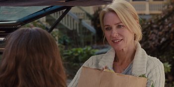 Movie still from “The Book of Henry” (2017), directed by Colin Trevorrow – A woman holding a brown bag under an open umbrella; Close Up shot, Over the shoulder angle