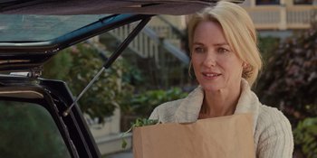 Movie still from “The Book of Henry” (2017), directed by Colin Trevorrow – A woman holding a paper bag while standing in the back of a car; Close Up shot, Over the shoulder angle