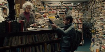 Movie still from “The Book of Henry” (2017), directed by Colin Trevorrow – A woman and a child are in a bookstore; Medium shot, Over the shoulder angle
