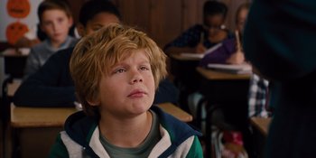 Movie still from “The Book of Henry” (2017), directed by Colin Trevorrow – A young boy sitting in a classroom; Close Up shot, Low angle